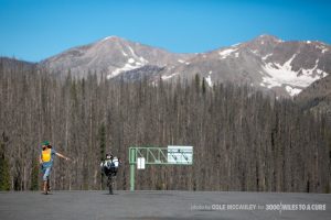 Chris Clemens points out that Rob has reached the summit of Wolf Creek Pass and is about to fly down the mountain.